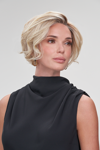 Model looking of to the side while wearing a short a-line pixie cut wig for women. Ignite by Jon Renau in the color 12FS8