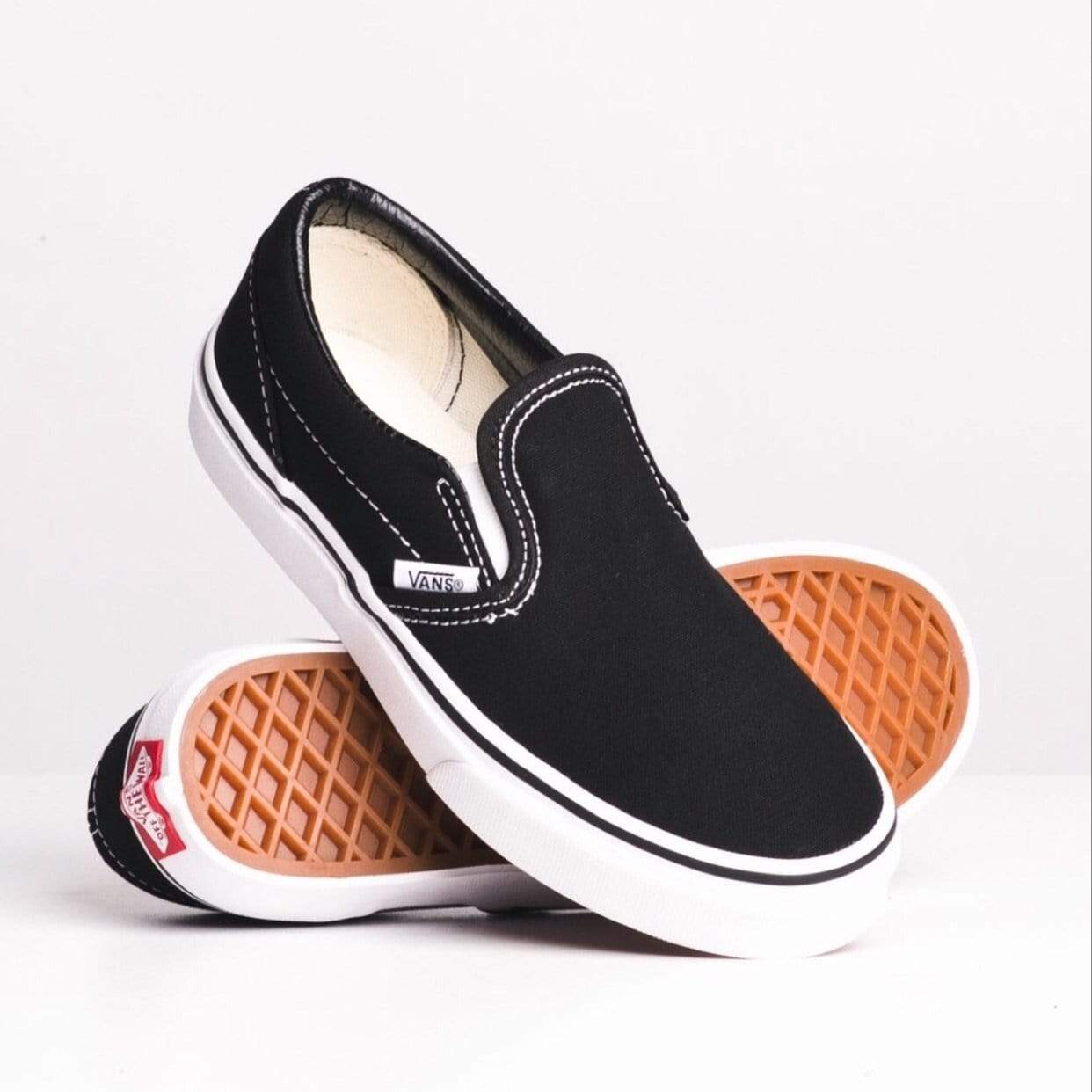 youth black slip on vans