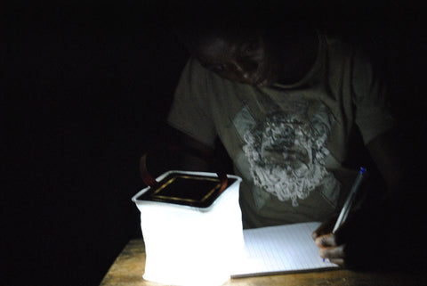 Girl using light to study.