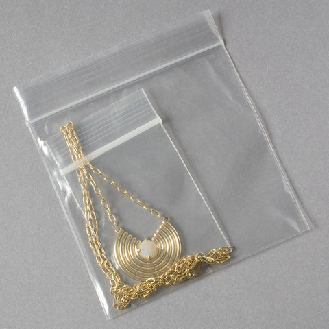 necklace packed in polybag with chain out and then packed in another zip polybag