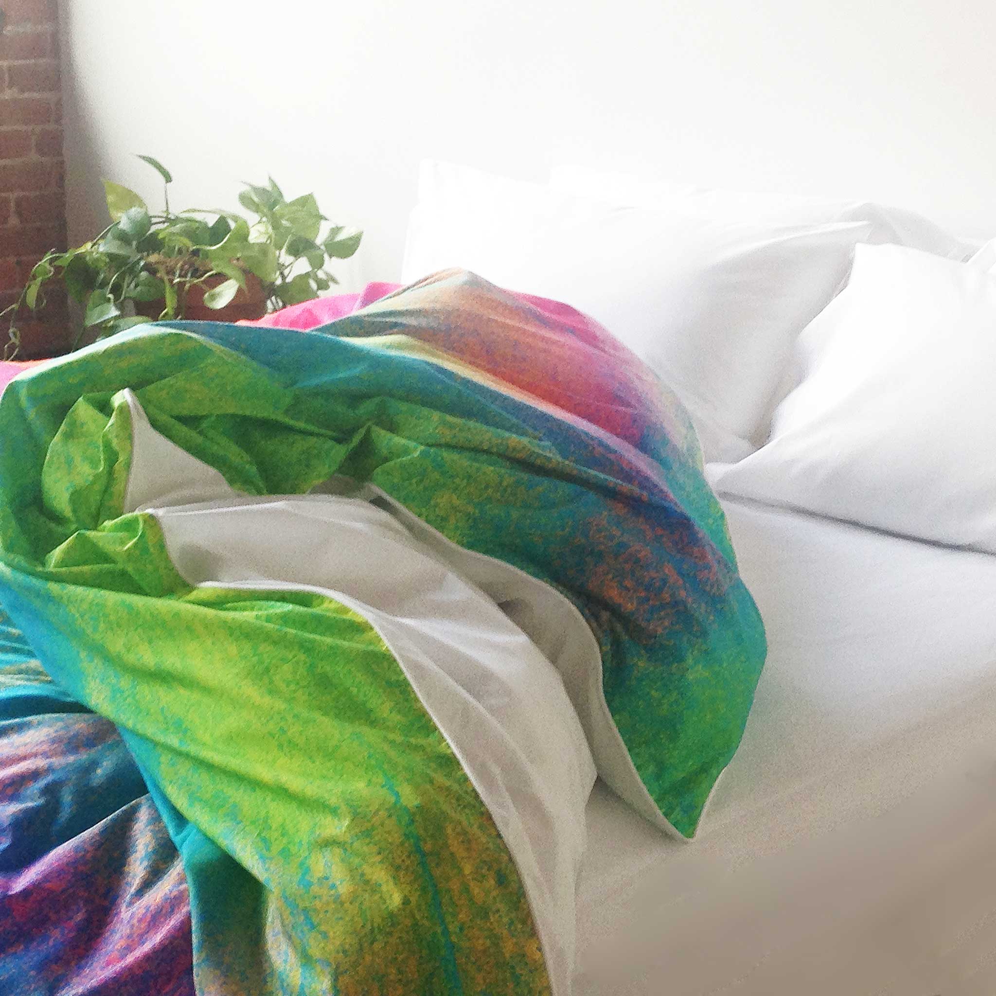 ZayZay luxury linen duvet cover Tropical Frost design bright colours tossed open on bed