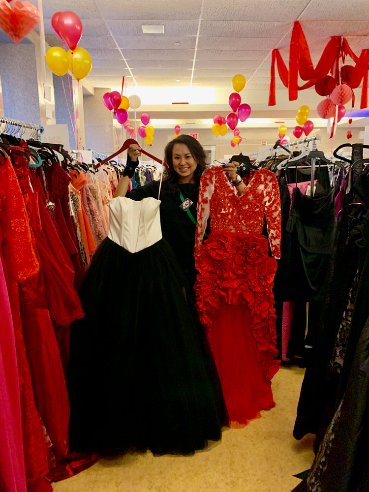 Stacey Chang Holding Donated Dresses