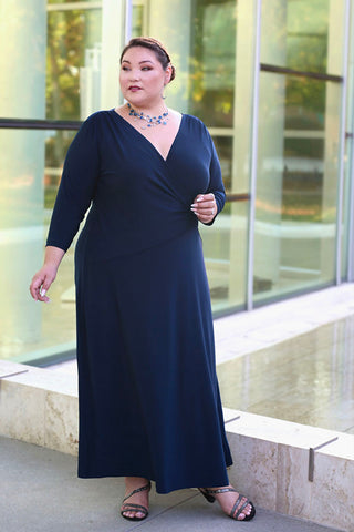 woman wearing a navy blue faux wrap dress