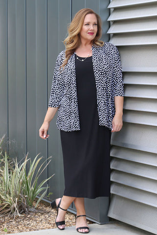 woman wearing a black and ivory random dot print jacket