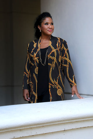 woman wearing a black and gold chain print jacket