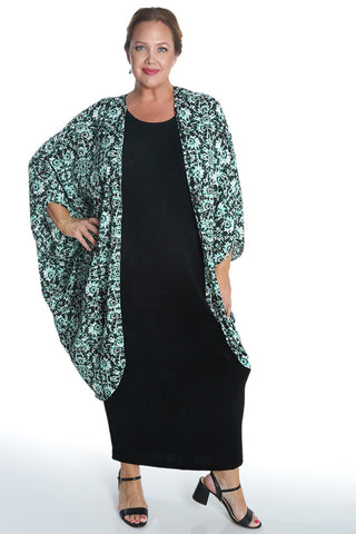 woman wearing a green print cocoon duster jacker