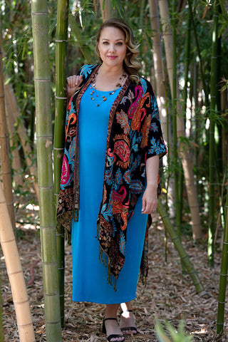 woman wearing a turquoise dress and bohemian shawl