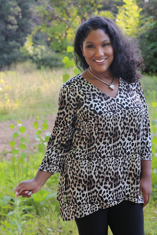 woman wearing animal print shark bite tunic