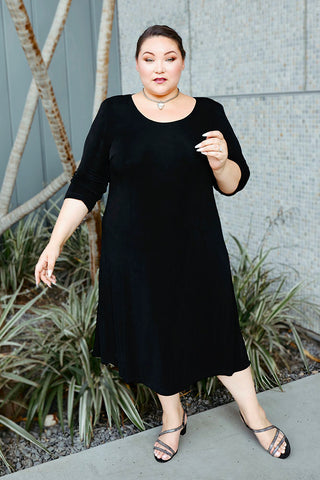 woman wearing a black a line dress