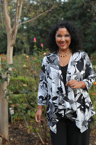 woman wearing a black and white floral sheer cardigan