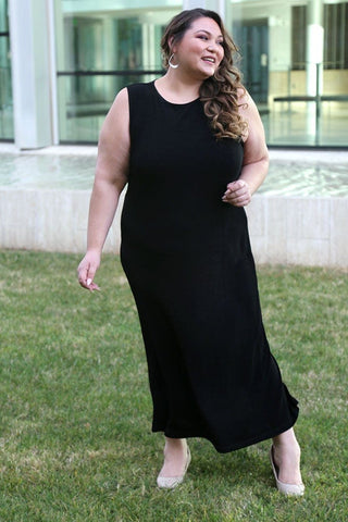 woman wearing a black jewel neckline maxi sheath dress