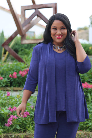 dark skinned woman with long straight black hair wearing a blue outfit