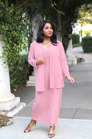 brown skinned woman with long straight black hair wearing a pink outfit