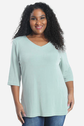 woman wearing a mint green v neck top