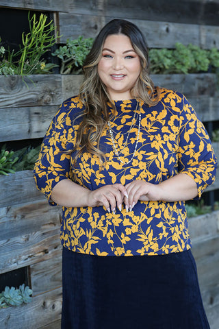 woman wearing a navy and yellow 3/4 sleeve top