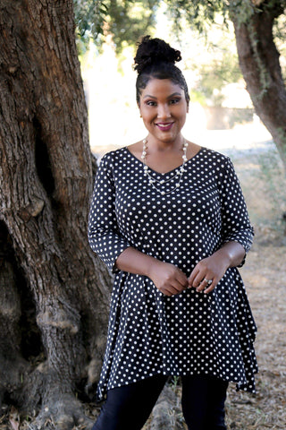 woman wearing a black and white polka dot tunic