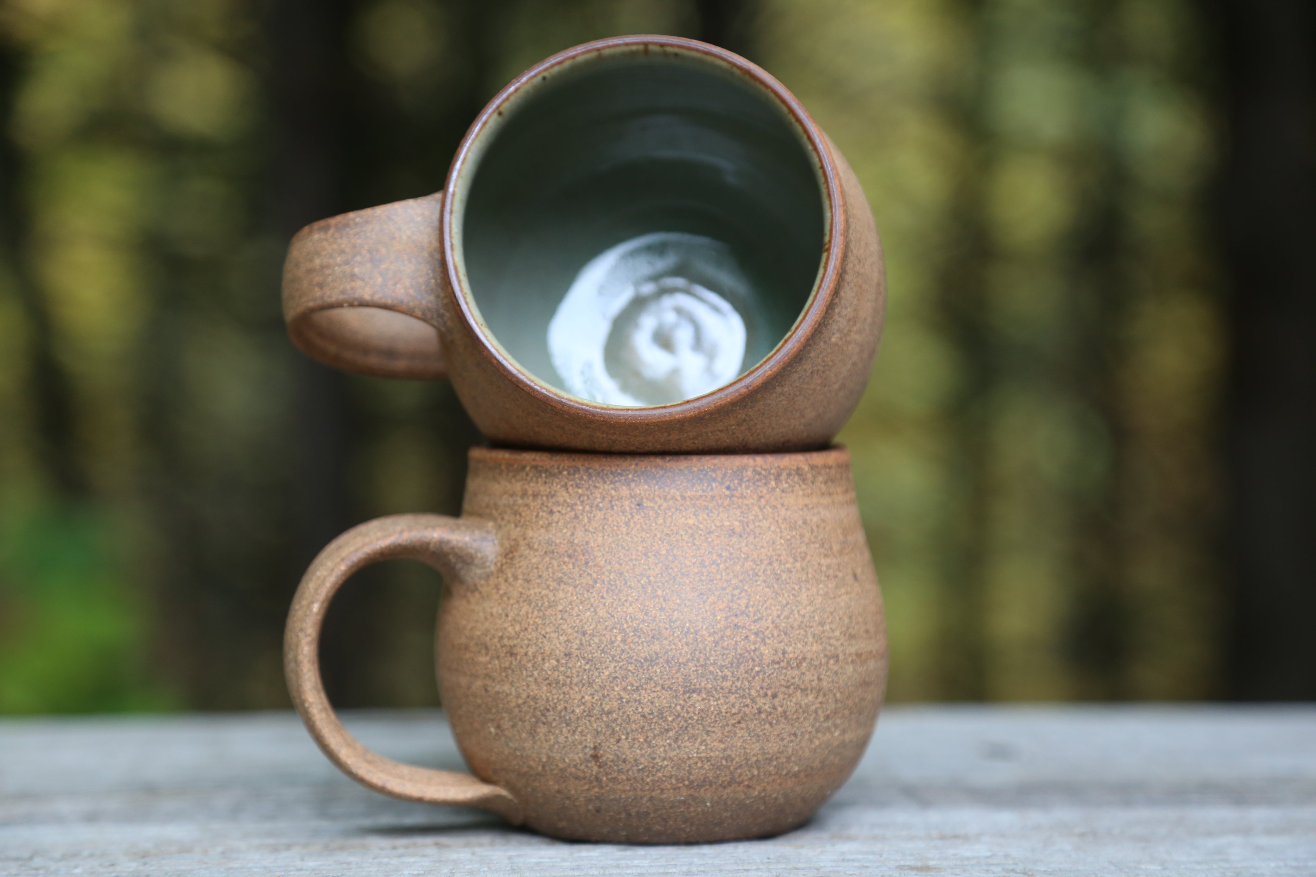 Pair of speckled bare clay mugs