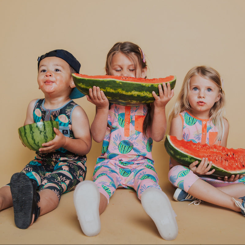 Kids in rompers eating watermelon. Rags unisex baby rompers