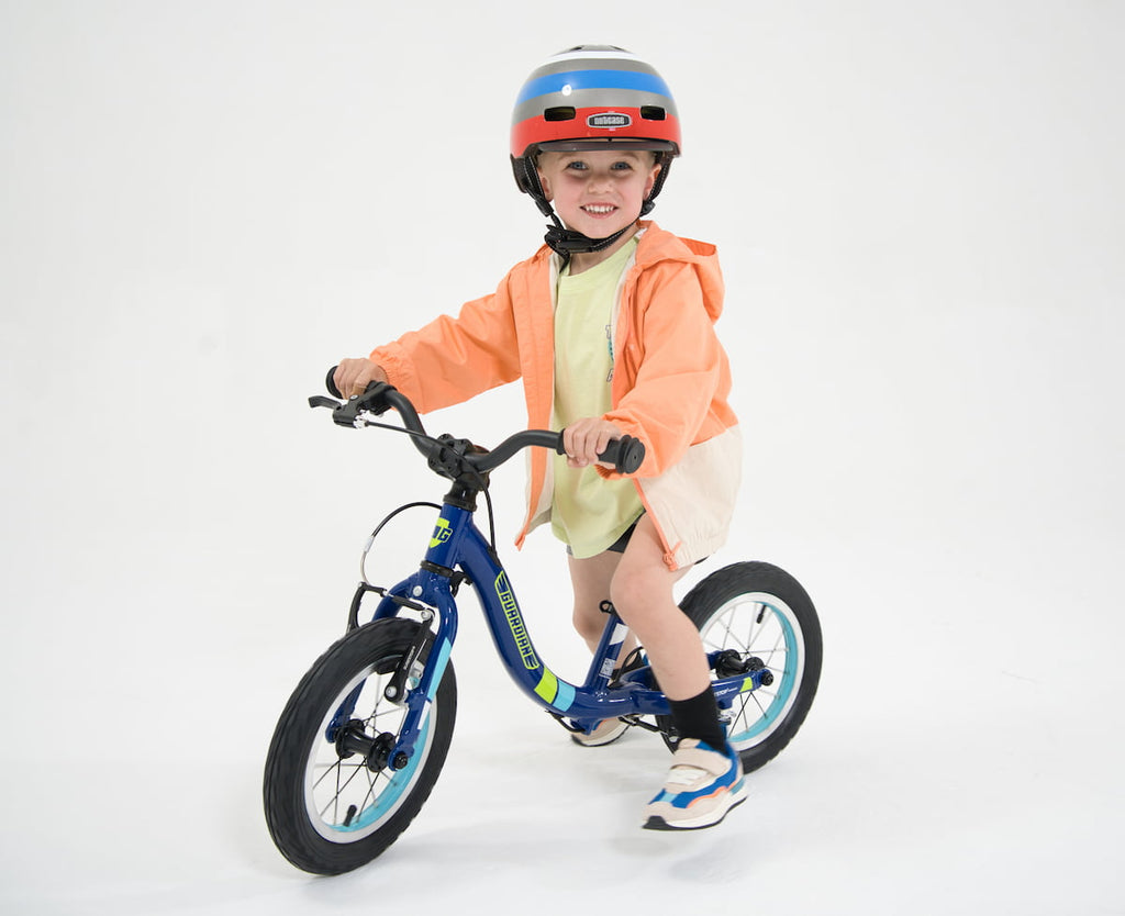 child on balance bike