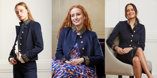 models wears Mayfair military jacket with cream blouse, multicoloured silk dress, and navy skirt