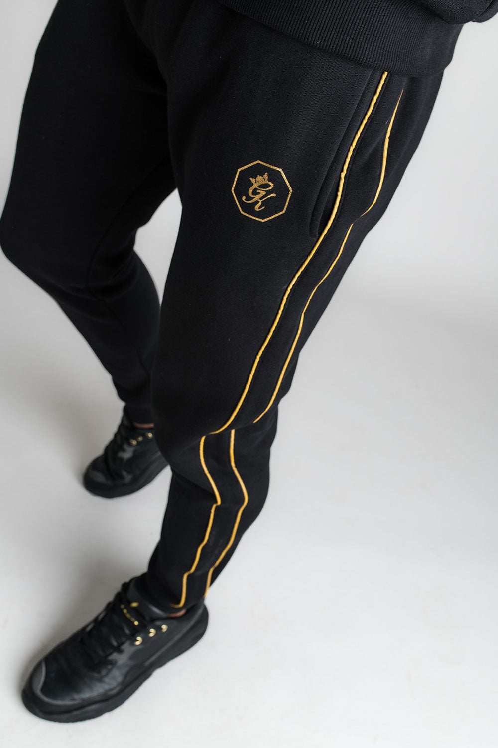 gym king black and gold joggers