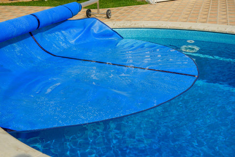 pool with cover half-way over it