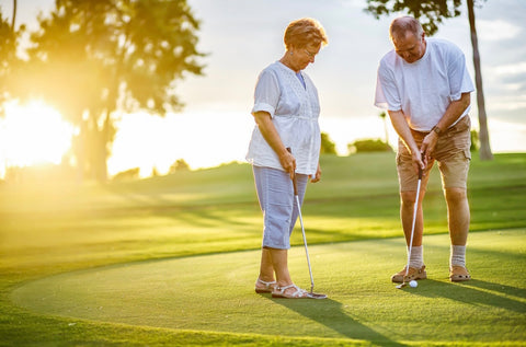 Couple playing golf while staying at RV park