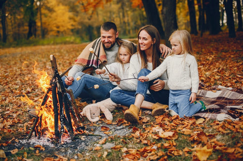 Family gathered around campfire