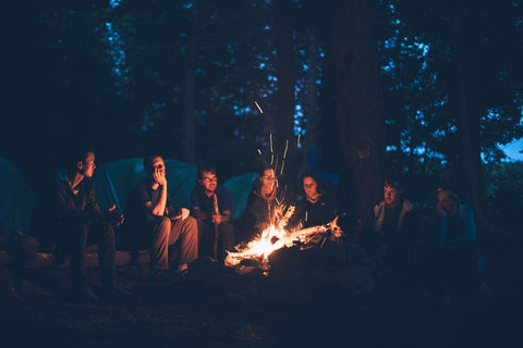 Friends and family sitting around a campfire