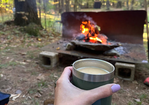 portable coffee cup by a campfire