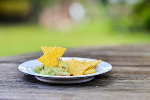 Chips and Guacamole on a Picnic Table