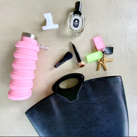 Que Collapsible water bottle in pink, keys, collapsible 4 in 1 brush by Woosh, The Diptyque L 'Ombre Dans Parfum