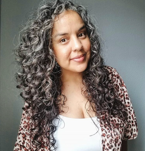 Latina woman with natural curly and silver hair