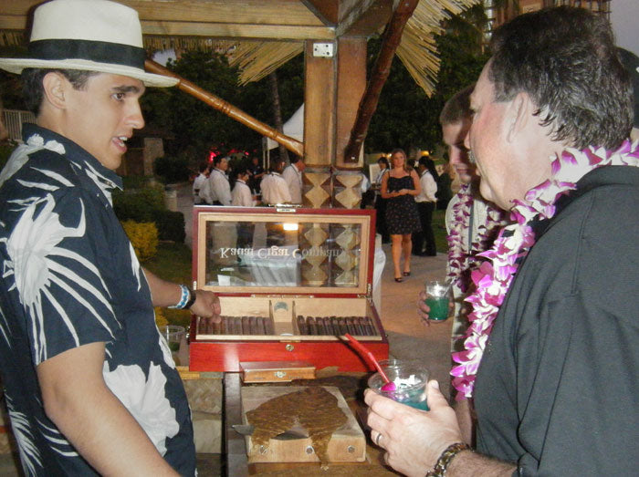 Cigar roller, Tai Erum, explaining the different Island Prince cigars to very interested guests as others arrive.