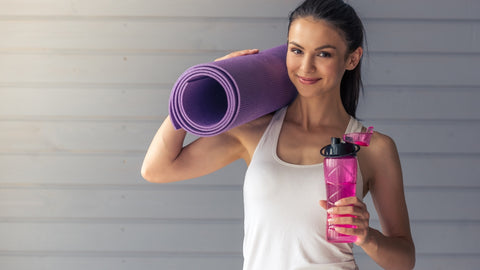 woman carrying a large exercise mat