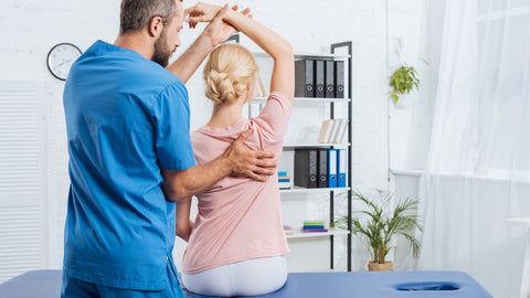 chiropractor helping a woman bad posture with waist trimmer