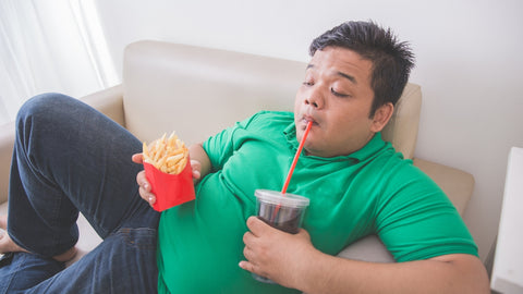 obese man eating 