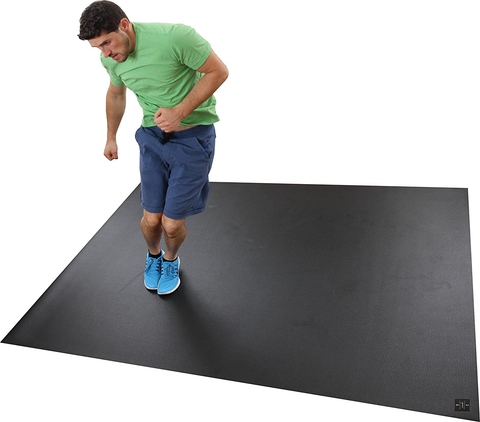 Man using a black workout mat for home gym