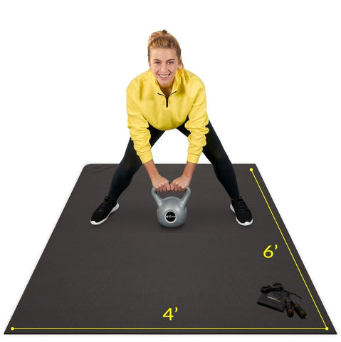 woman using Active Gear's best workout mat in black using home workout essentials kettle bell and skipping rope