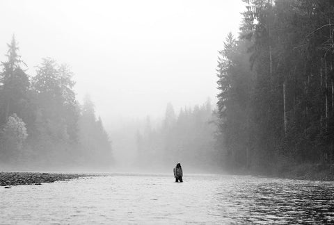 man fly fishing in rain