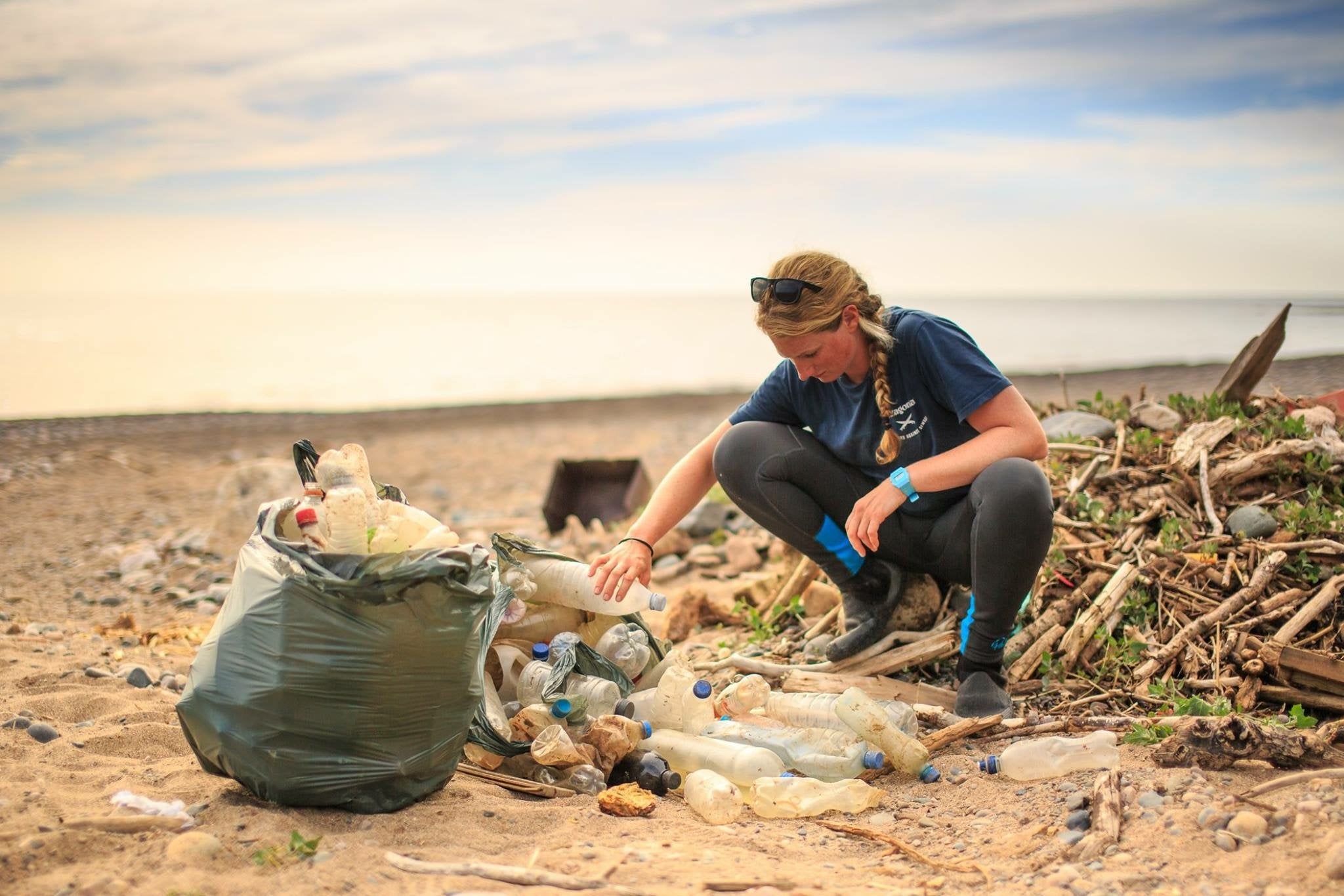 Cal Major collecting trash on a beach