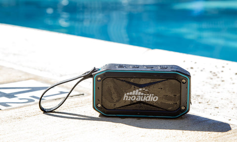 The Float is a small waterproof Bluetooth speaker. It's shown here on the deck of a swimming pool. It's also perfect for other environments that could expose technology to water, like lakes, rivers and the beach. It's made by H2O Audio, a company based in Southern California.  