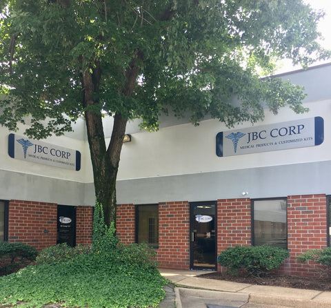 Brick building with two entrance doors JBC Corp sign above both doors