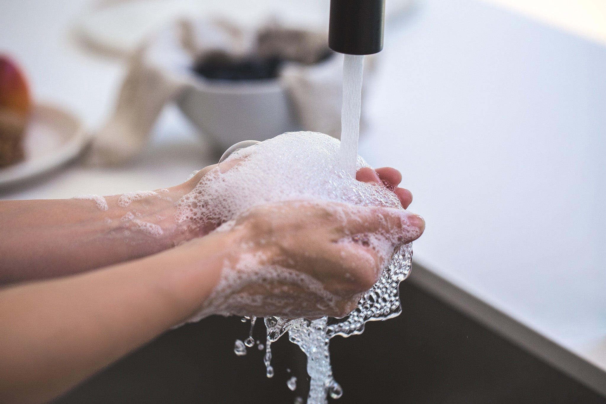 rinsing soapy hands