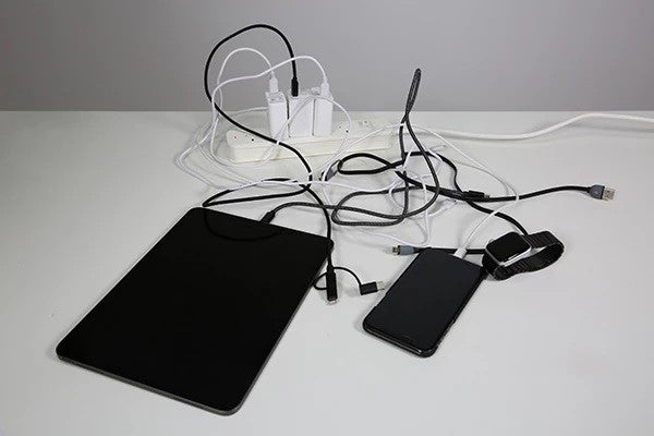 A montain of cables, charging Apple devices can be a mess