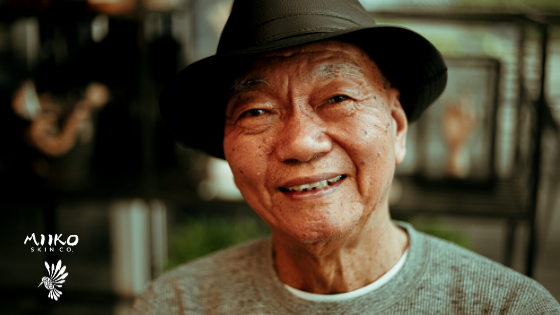 older man with hat smiling