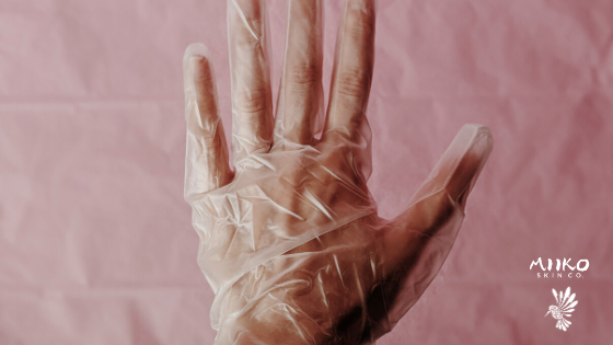 hand in glove with pink background