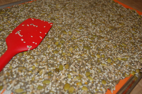 Seed crackers being spread in a pan