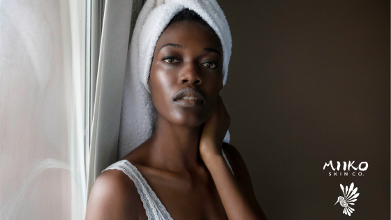 woman with towel on head looking at camera