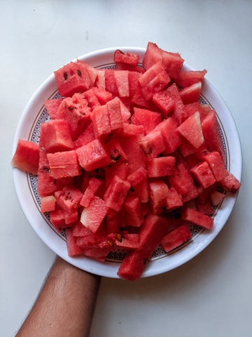white bowl full of cubed watermelon slices. 
